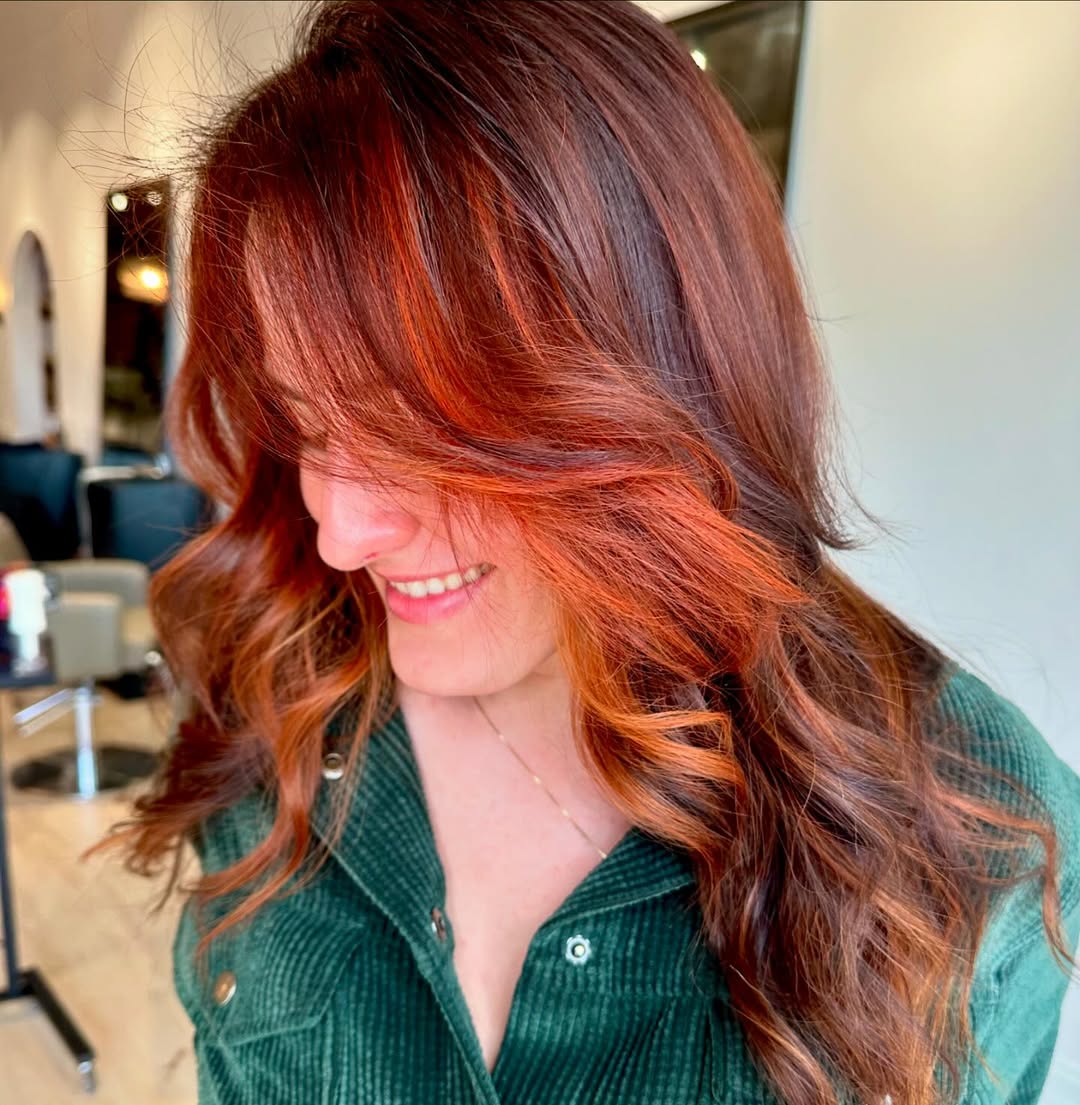 Copper Hair Summer Ideas 2026: Crochet & Denim Look Woman with vibrant copper hair smiling outdoors, wearing a white crochet top and denim shorts, perfect for copper hair summer ideas 2026.