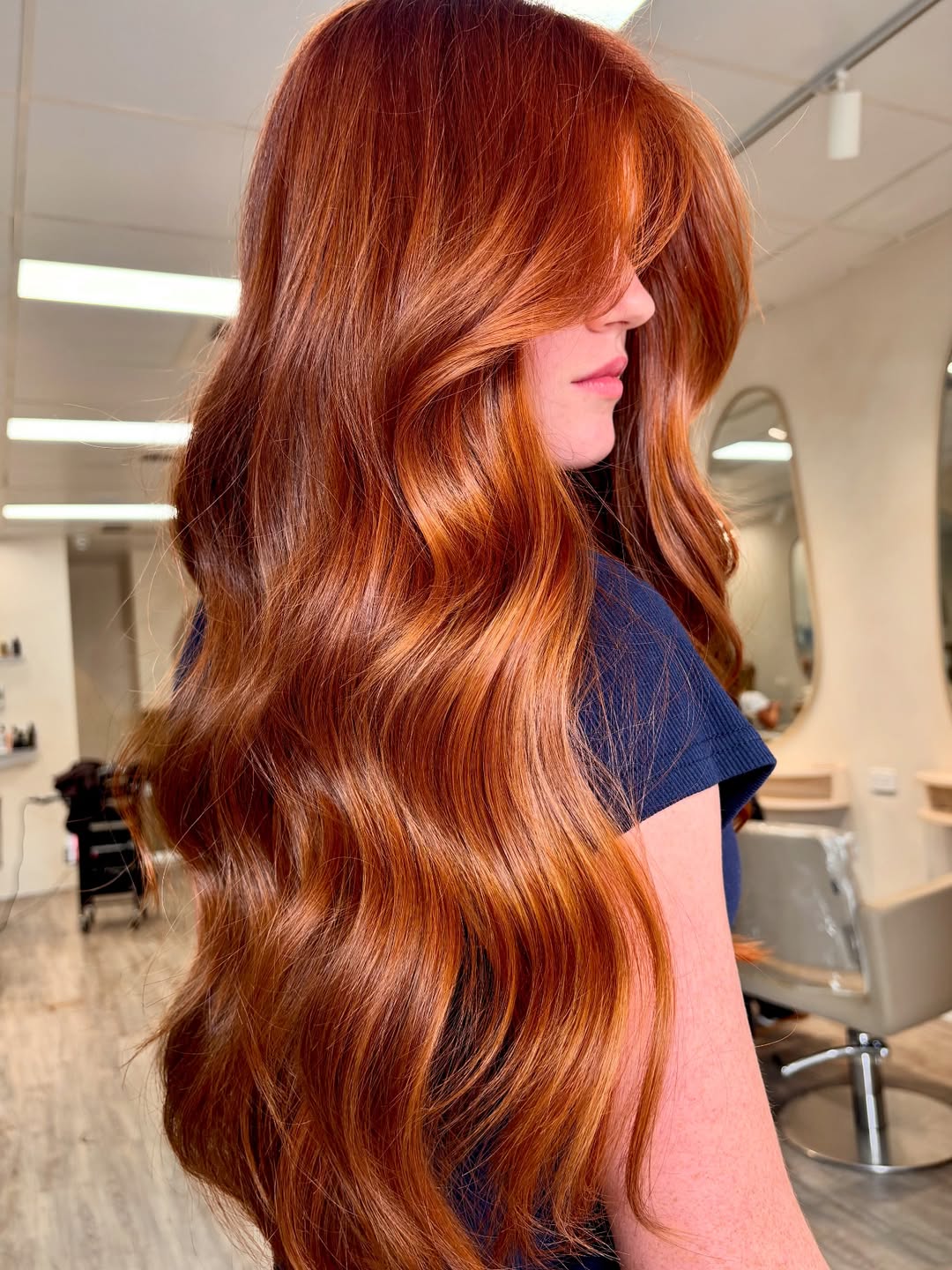Copper Hair Summer Ideas 2026: Chic Casual Style A woman with radiant copper hair styling a chic white halter neck top and high-waisted denim shorts, perfect for copper hair summer ideas 2026. She exudes casual elegance.