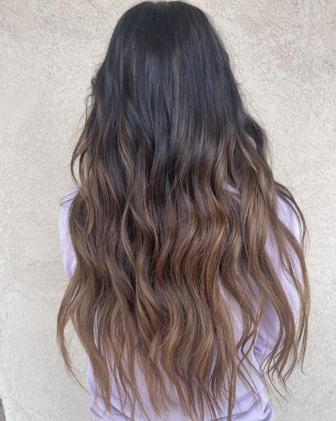 Effortless Braided Ponytail for Long Hair Summer 2026 Close-up of a woman with long, sun-kissed hair styled in a messy, braided ponytail, perfect for long hair summer hairstyles 2026. She's wearing a casual white off-the-shoulder top.