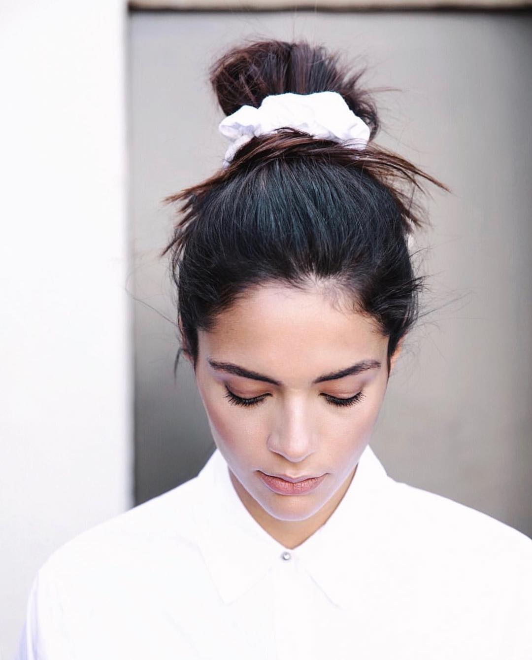 Braided Crown: Simple Summer Hairstyle 2026 An effortless braided crown, showcasing simple summer hairstyles for 2026, perfect for a casual daytime look. The hair is adorned with delicate wildflowers, enhancing its relaxed vibe.