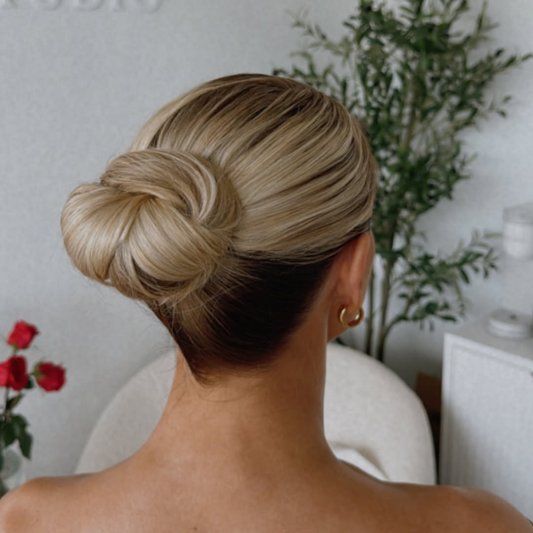 Elegant brunette bride with delicate floral hair accessory for her summer bride hairstyles 2026. Her hair is styled in soft, romantic waves.