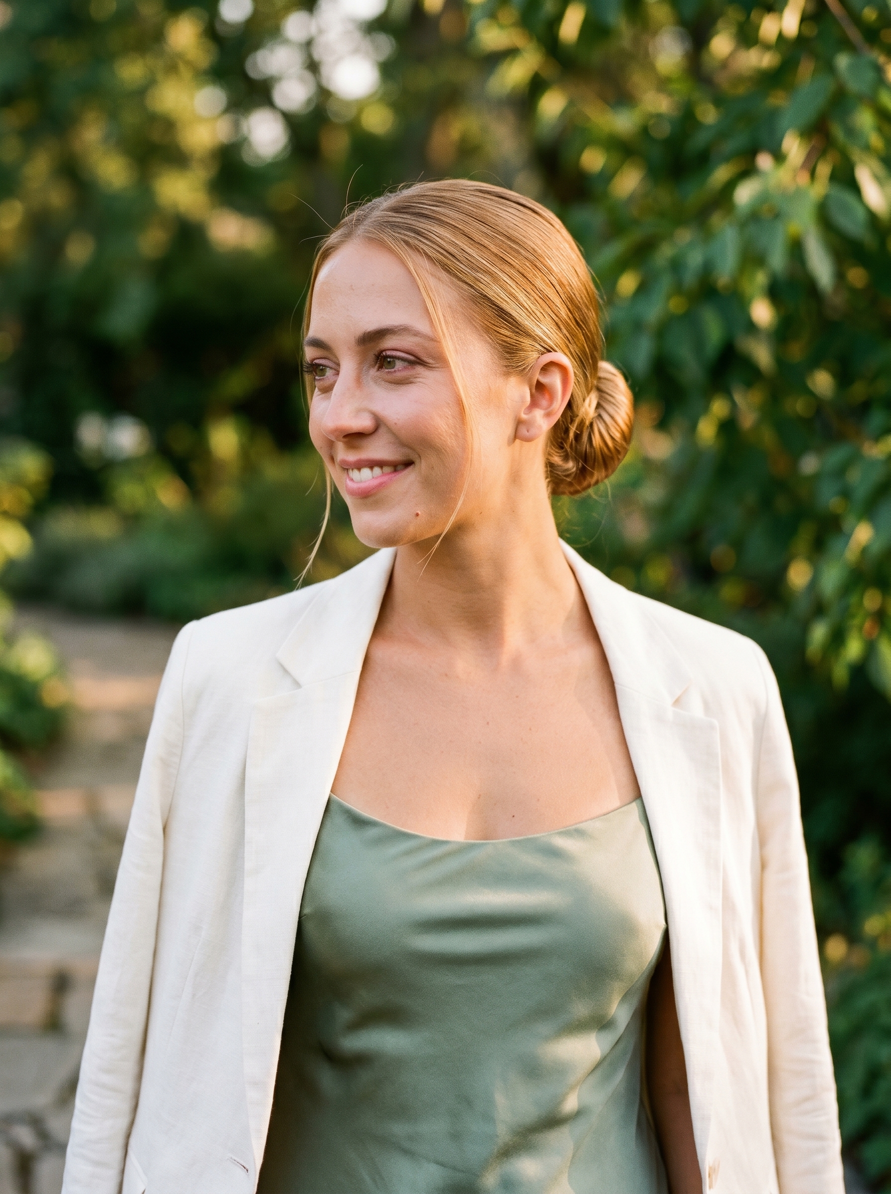 Elegant 'Hydrated' low bun for summer bride hairstyles 2026, featuring a Nectar Blonde glaze with warm, creamy blonde tones and a high-shine 'glass hair' effect, perfect for a sophisticated wedding.