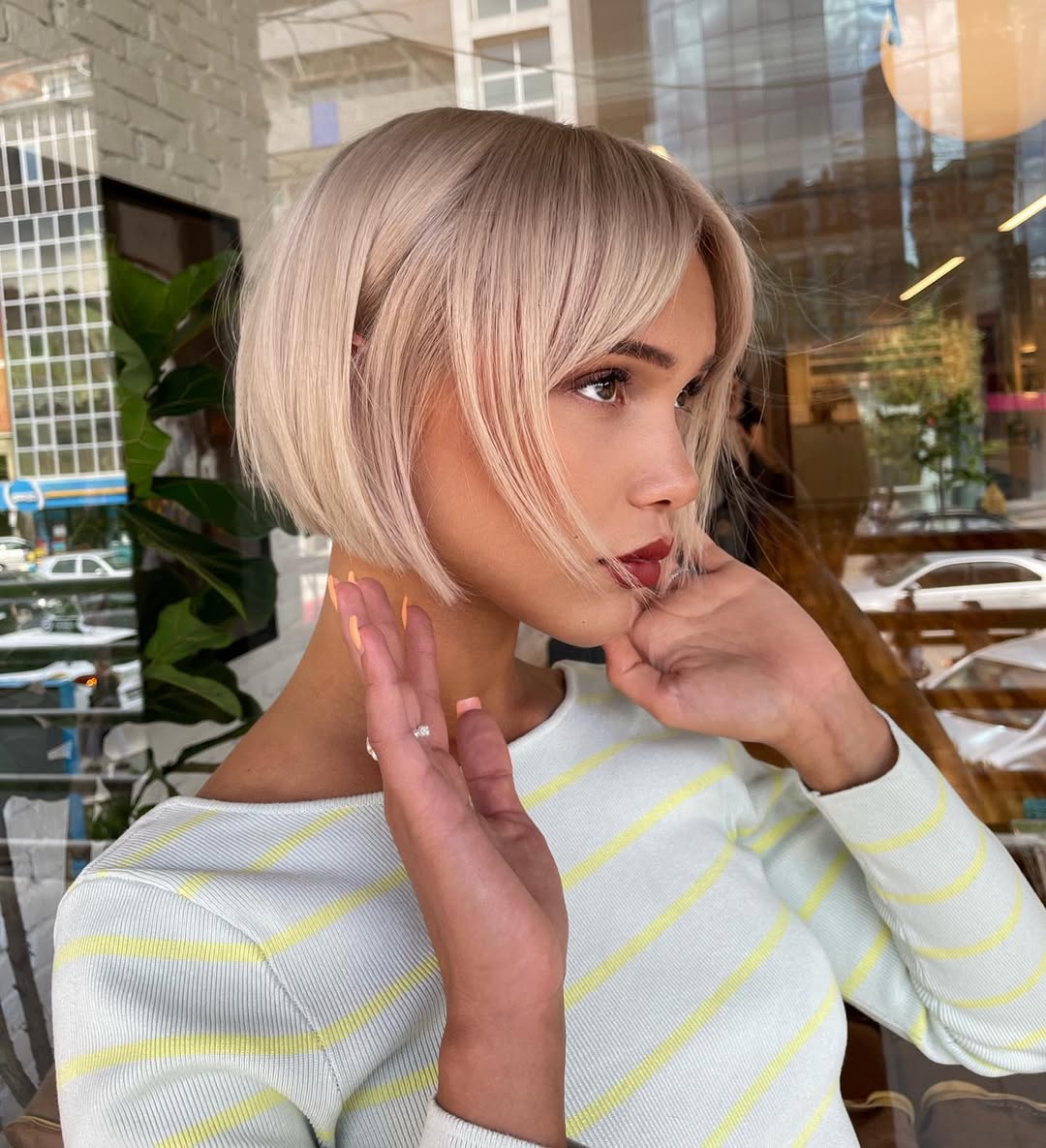 Effortless Beach Waves for Summer Hairstyle Ideas 2026 Close-up of a woman with long, sun-kissed blonde hair styled in loose beach waves, perfect for summer hairstyle ideas 2026. Her hair has subtle highlights framing her face, creating a soft, natural look.