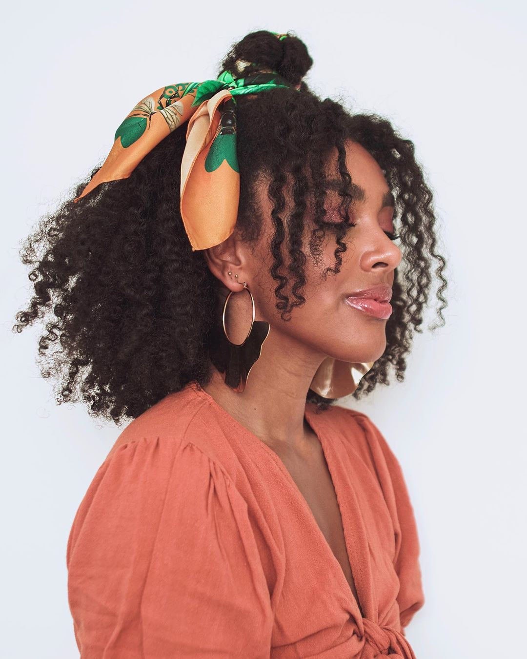 Chic Half-Up Braids: Summer Hairstyle Ideas 2026 Close-up of a woman with a half-up braided style, perfect for summer hairstyle ideas 2026. Her blonde hair features delicate braids pulled back, framing her face.