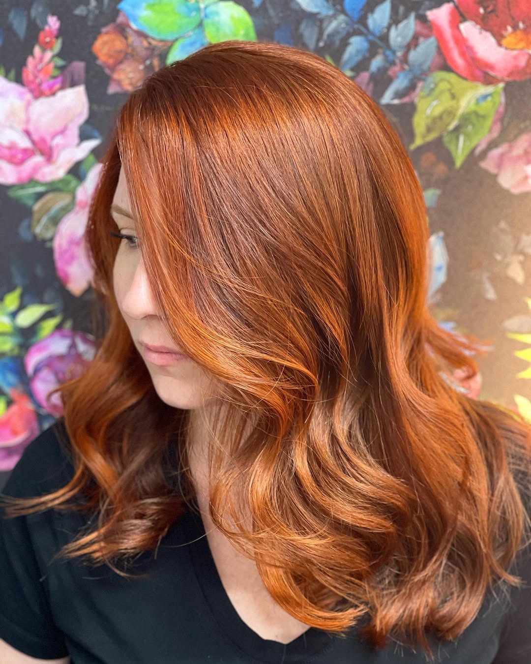 Chic Summer Red Hair Looks 2026: Picnic Perfect Style A woman with vibrant summer red hair looks 2026, styled in loose waves, wearing a floral sundress enjoying a sunny outdoor picnic. Perfect for a casual summer day.