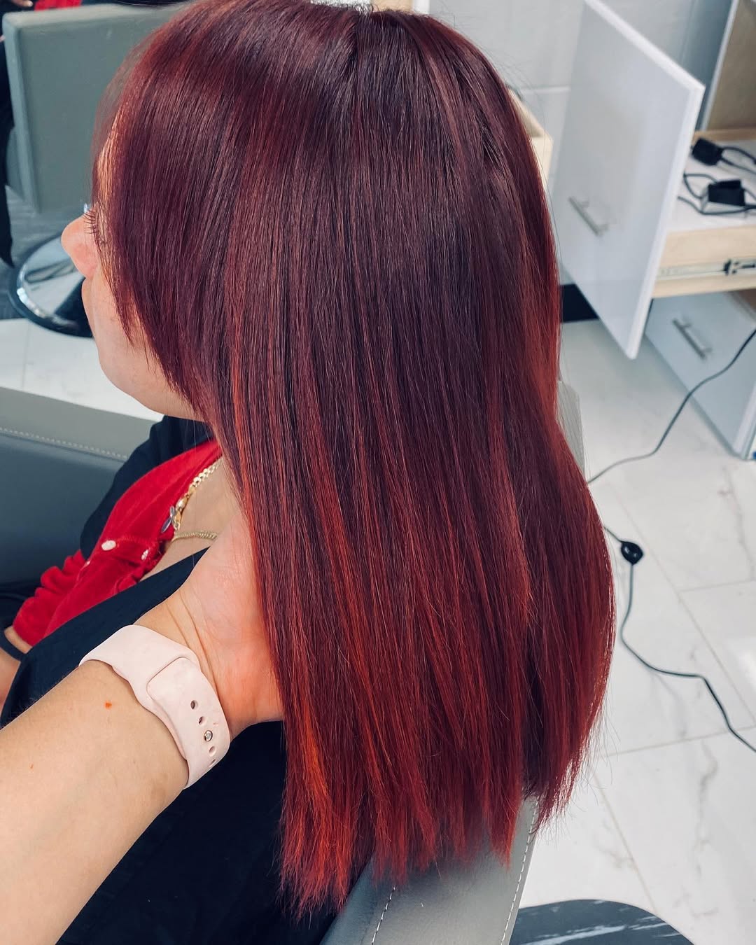 Summer Red Hair Looks 2026: Chic Ponytail A woman with stunning, fiery red hair styled in a chic high ponytail, showcasing a trendy summer red hair look 2026 for a sophisticated yet playful vibe.