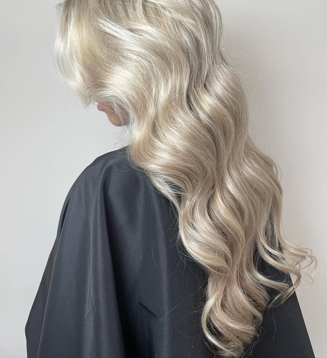 Close-up of a woman with radiant summer soft hair color 2026, showcasing sun-kissed blonde balayage with warm undertones, perfect for a bright casual day out.