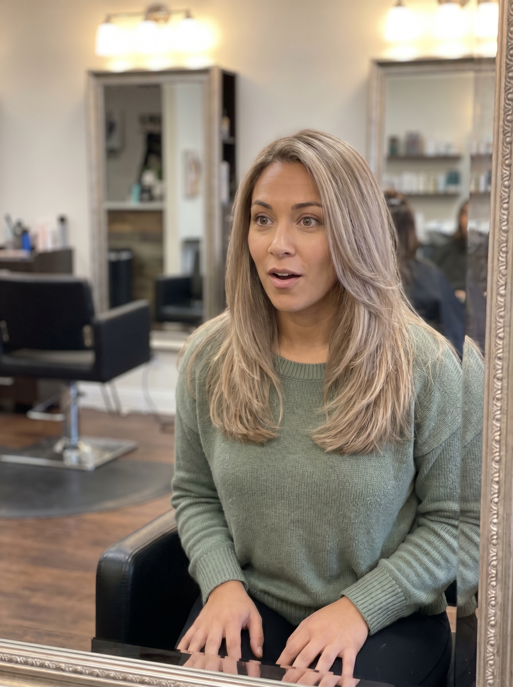 Close-up of hair showcasing a refined beige blonde 'Quiet Luxury' gloss, a sophisticated summer soft hair color 2026. This muted, elegant shade is perfect for everyday, work, or special occasions, offering a soft, luminous finish.