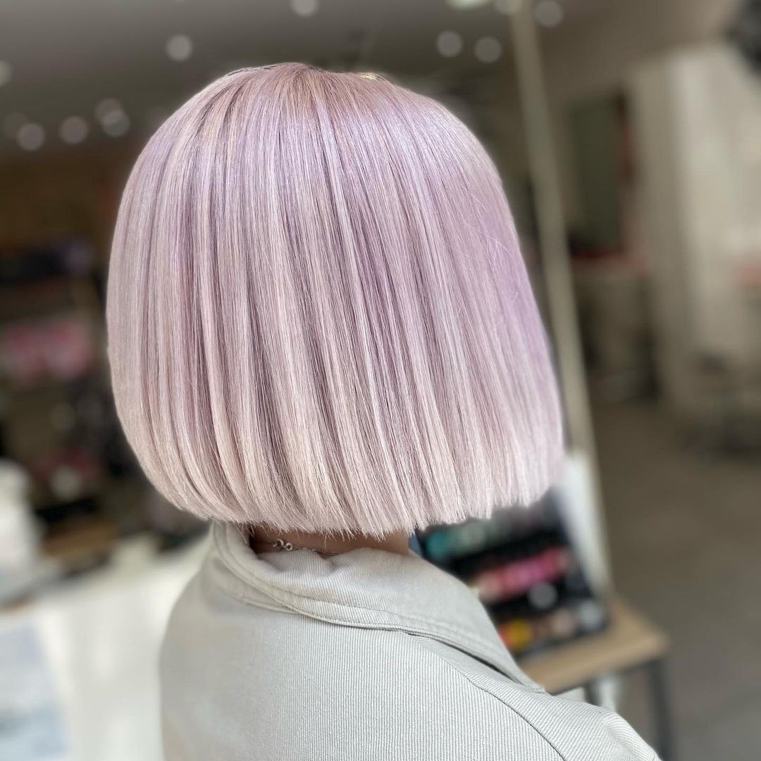 Close-up of a woman with long, flowing hair showcasing a beautiful 'summer soft hair color 2026' with subtle honey and caramel balayage, perfect for sunny days.