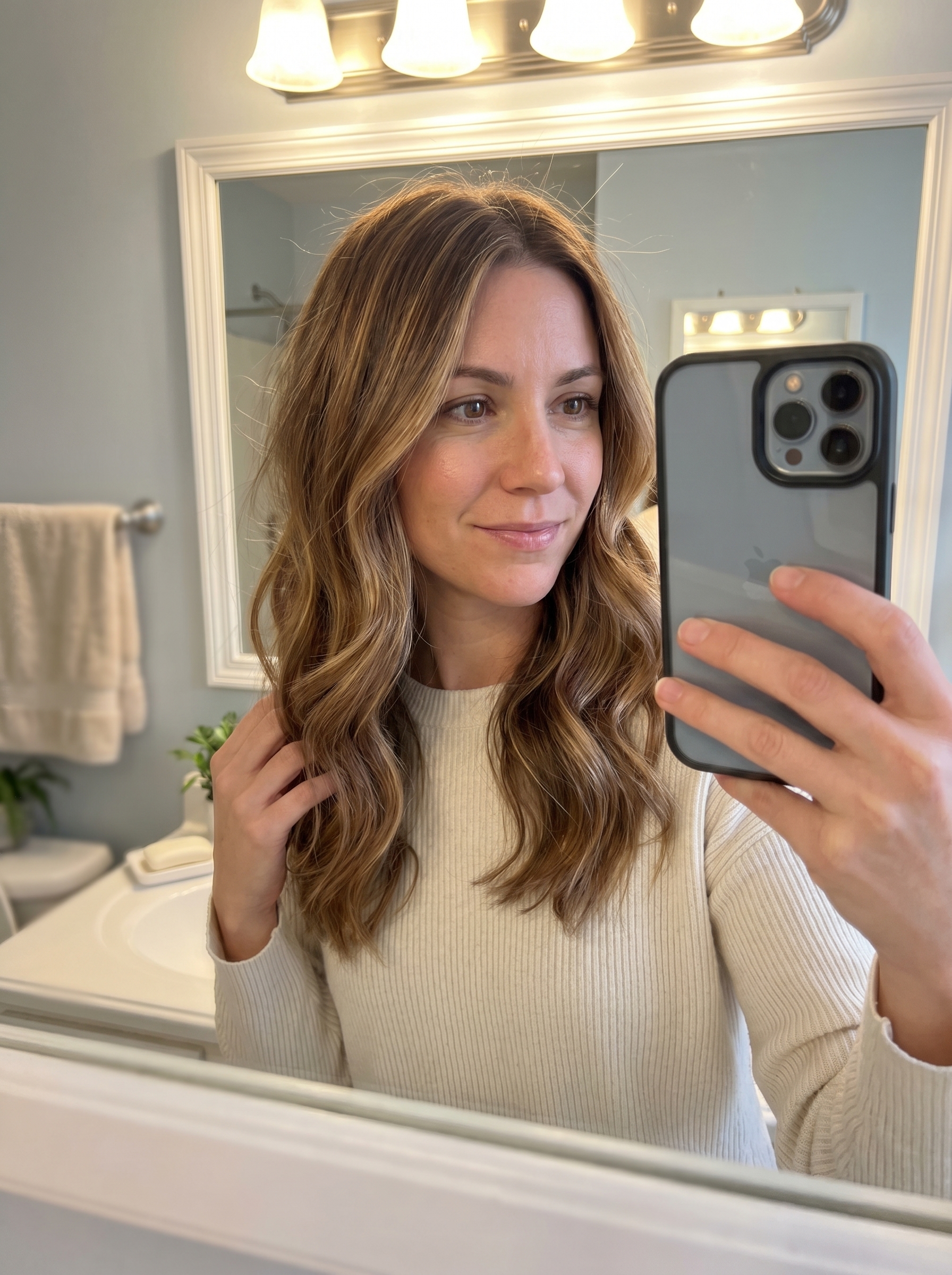 Sun-drenched toffee ribbons hair with warm caramel and golden brown tones, a rich and lived-in summer soft hair color 2026. This beautiful look is perfect for everyday, special occasions, or vacation, boosted by Kristin Ess gloss and UV spray.
