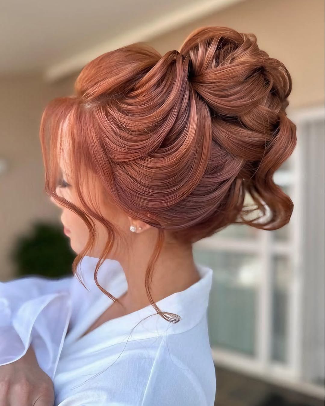 Beautiful blonde bride with a classic chignon bun, perfectly showcasing elegant summer wedding hairstyle ideas 2026. Her hair is intricately styled for a sophisticated bridal look.