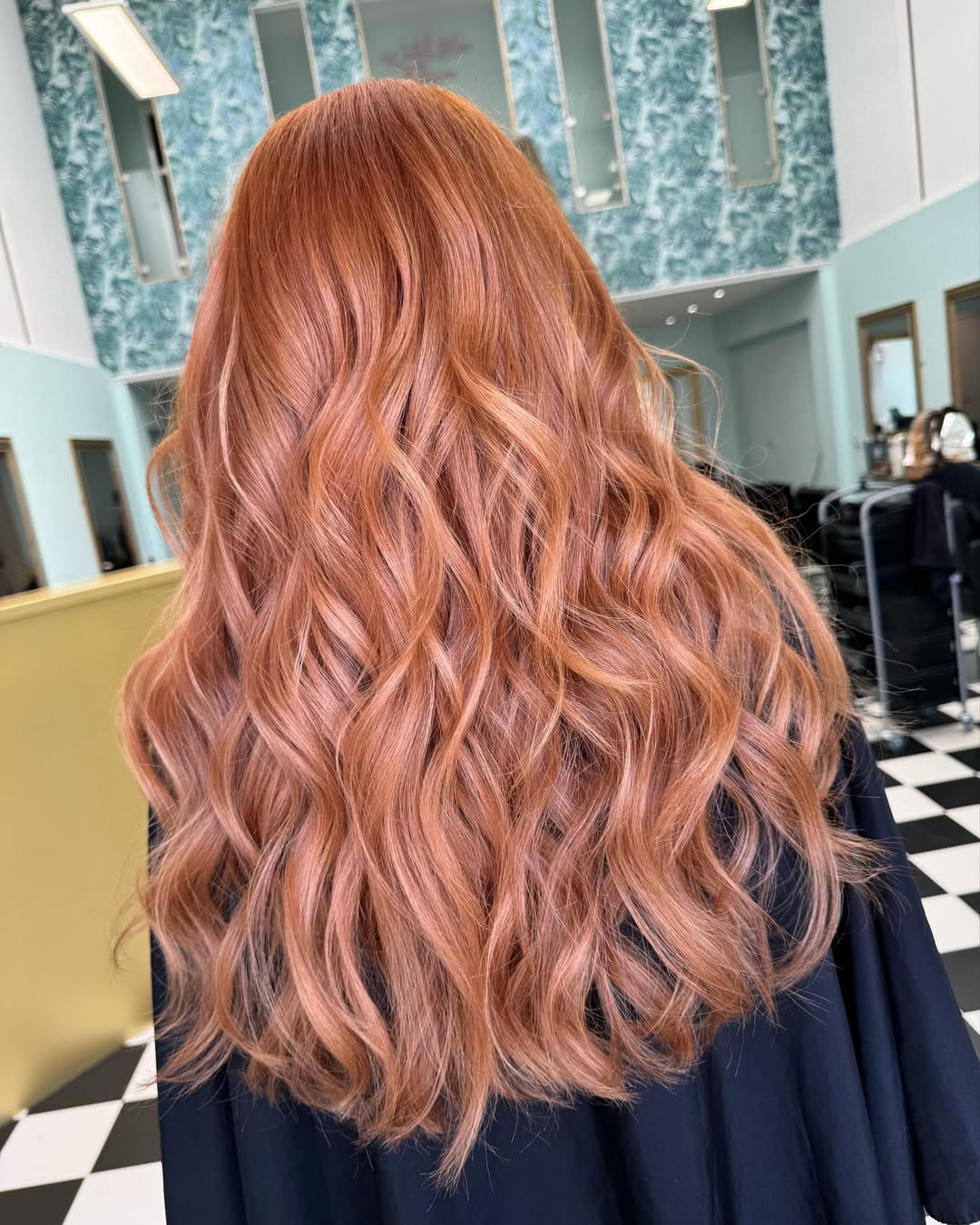 Stunning Beach Waves Hair Summer 2026 Style Guide Close-up of a woman with natural, sun-kissed beach waves hair, perfect for summer 2026, paired with a white off-shoulder top for a relaxed, chic vacation look.