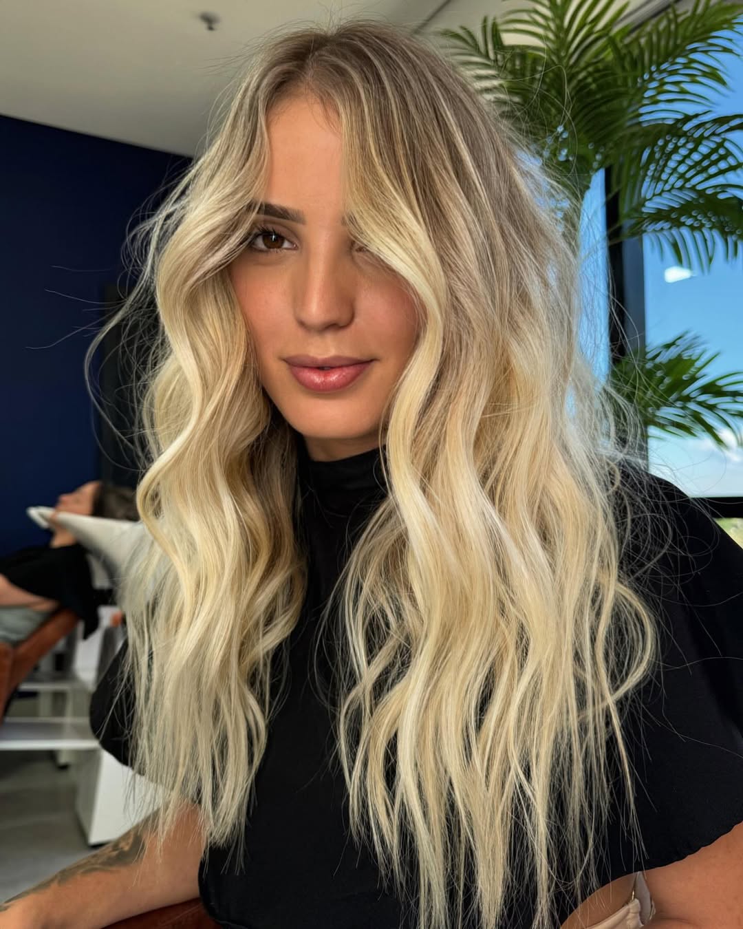Effortless Beach Waves Hair Summer 2026 Close-up of a woman with natural looking beach waves hair, styled for summer. Her sun-kissed blonde hair falls softly around her shoulders, showcasing a relaxed and effortless look perfect for vacation or everyday wear.