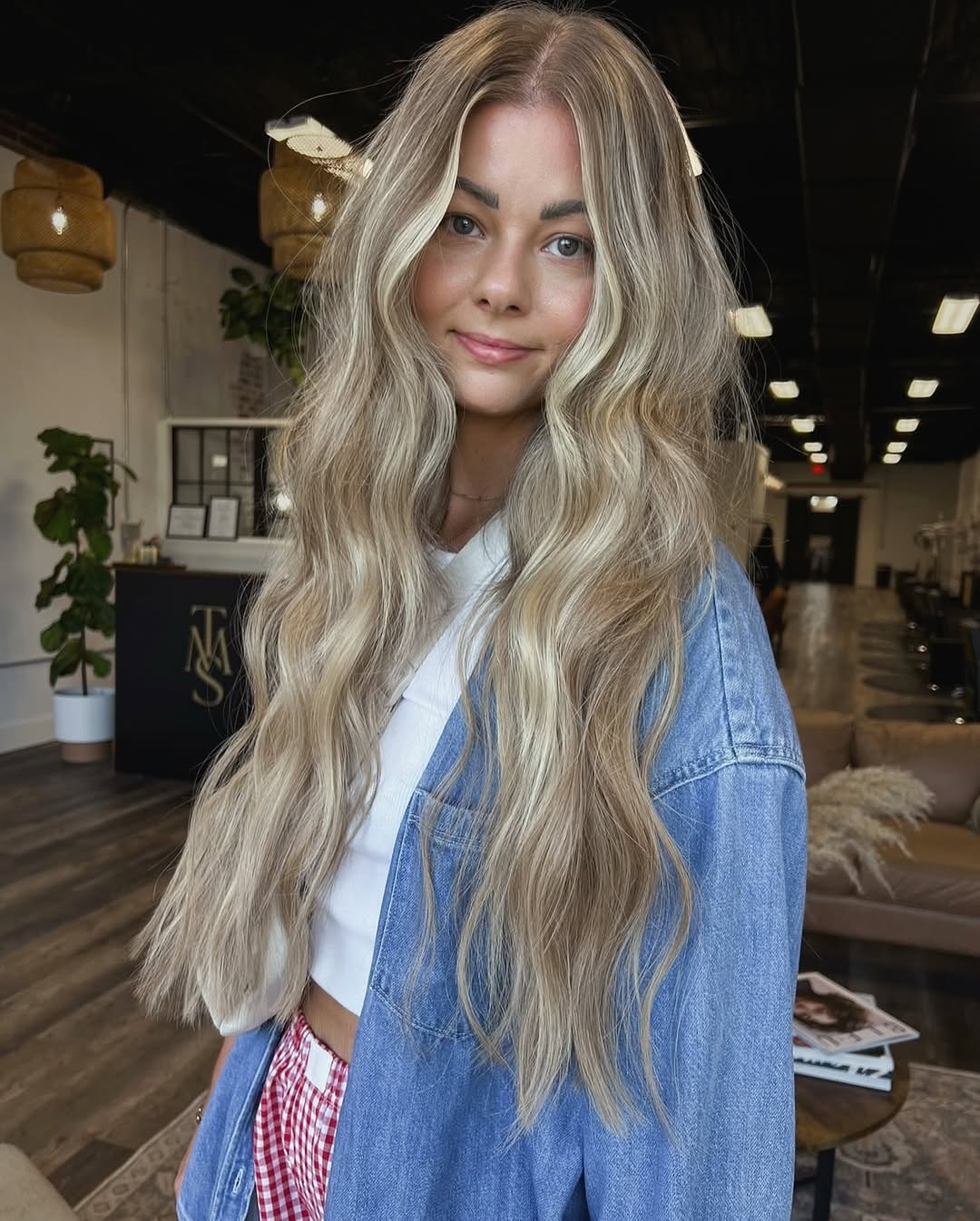 Stunning Beach Waves Hair Summer 2026 Look Woman with long, sun-kissed beach waves hair summer 2026, wearing a flowy white sundress and sunglasses, walking on a sandy beach.