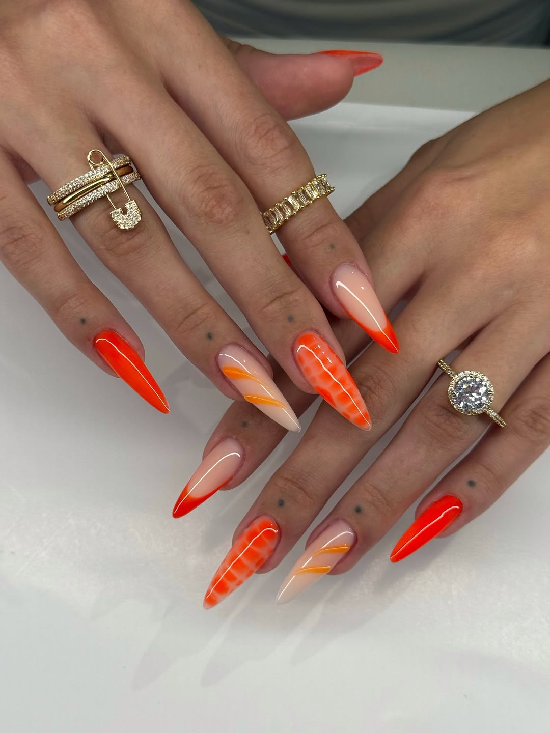 Bright Orange Glossy Stiletto French And Swirl Nails