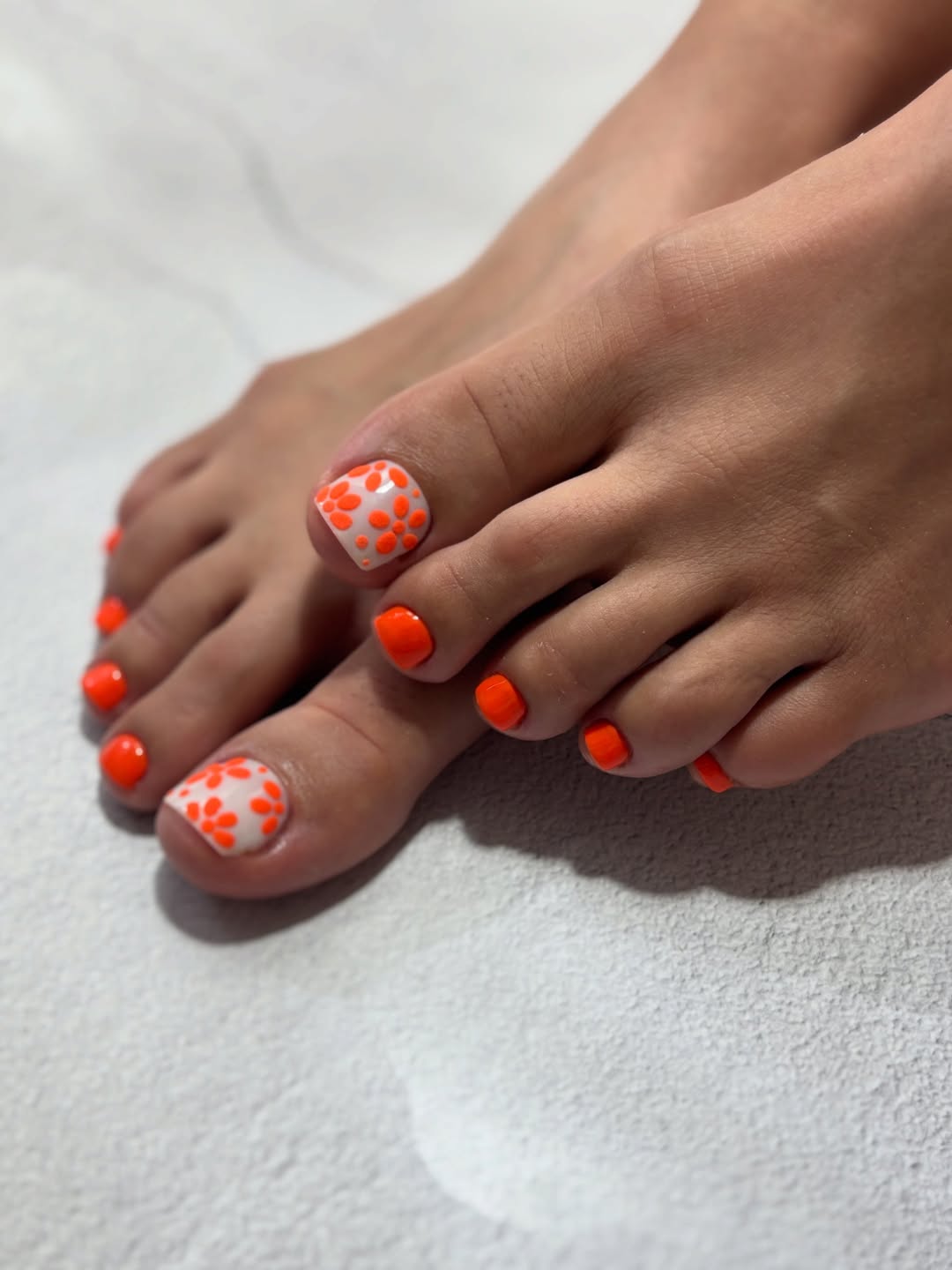 Bright Orange Pedicure with White Daisy Dot Accents