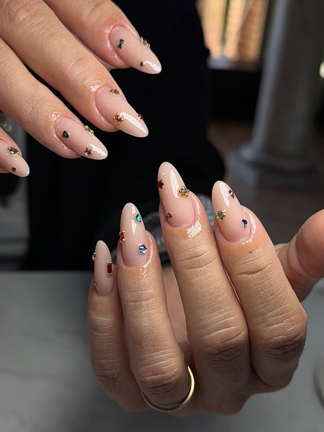 Clear Nude Almond Nails with Scattered Rhinestone Charms