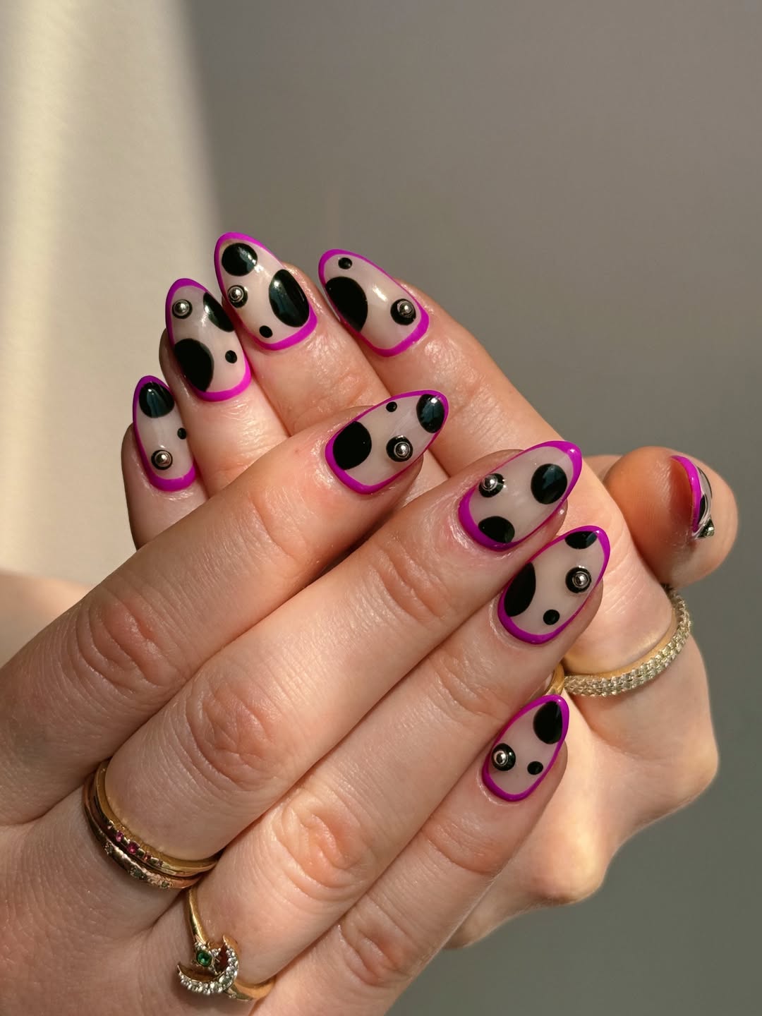 Funky Black Dotted Almond Nails with Magenta Outline