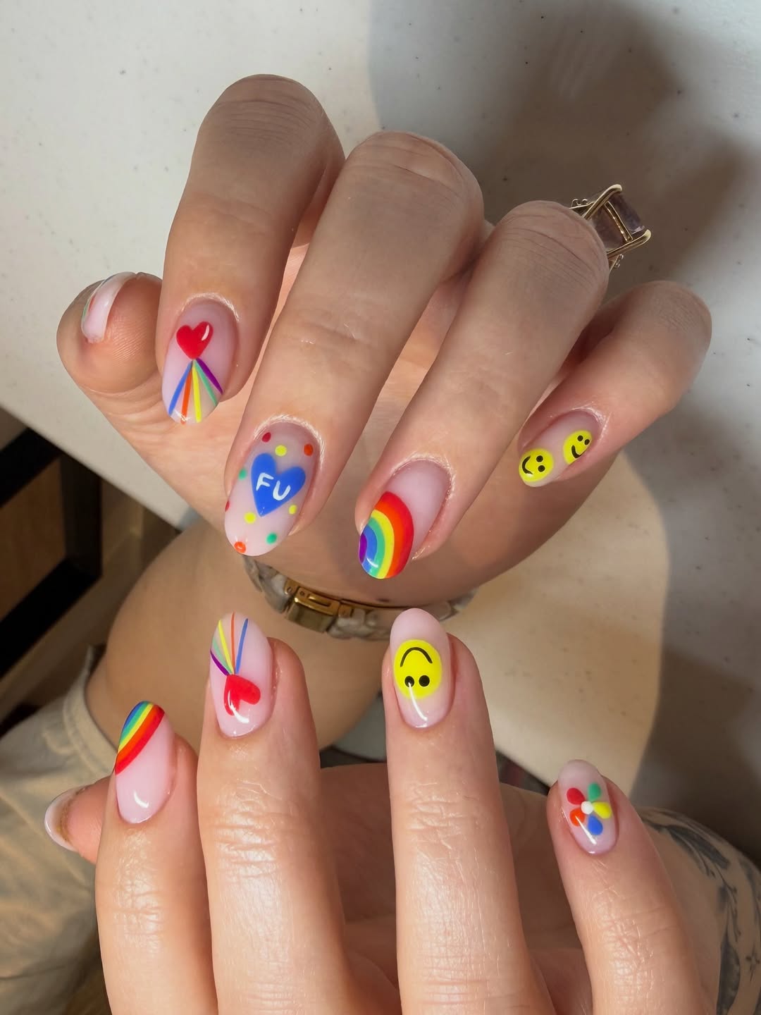 Funky Rainbow Art on Milky Pink Oval Nails