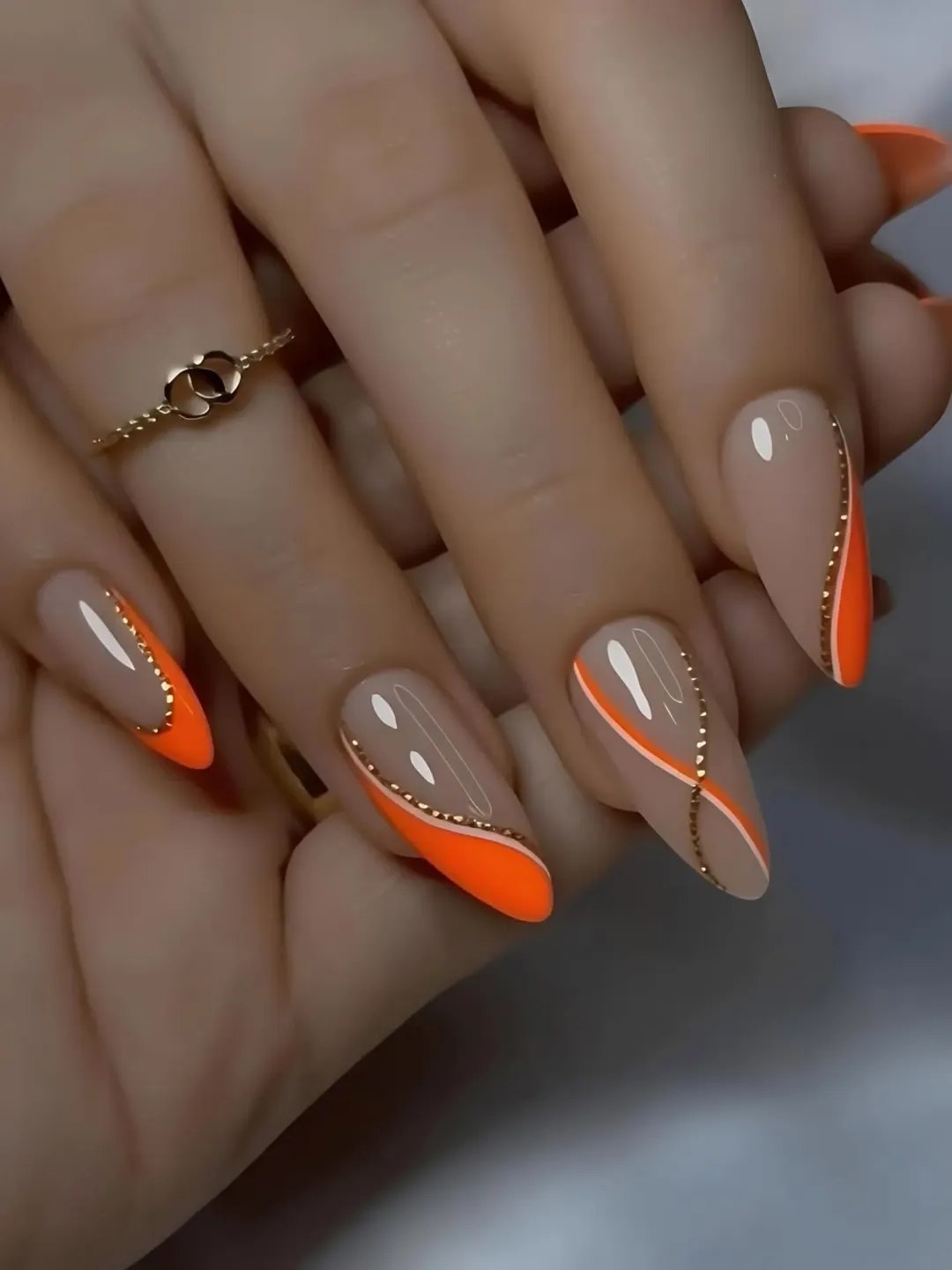 Glossy Nude Orange Swirl Gold Accent Almond Nails