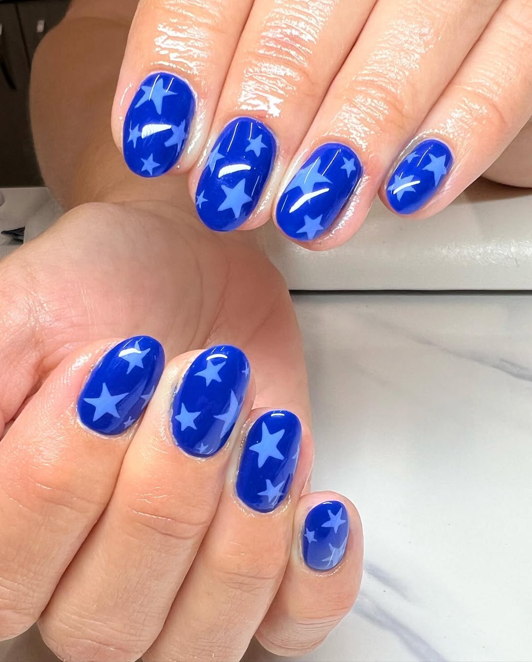 25 Patriotic Nail Ideas for 2026 You’ll Love 15 Glossy Royal Blue Star Pattern Oval Nails