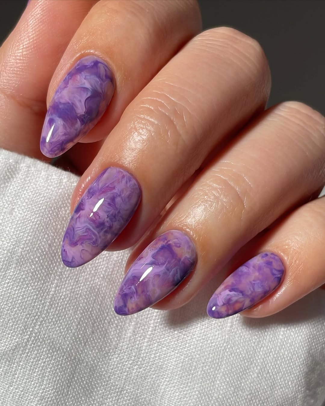 Glossy Swirling Purple Marble Almond Nails