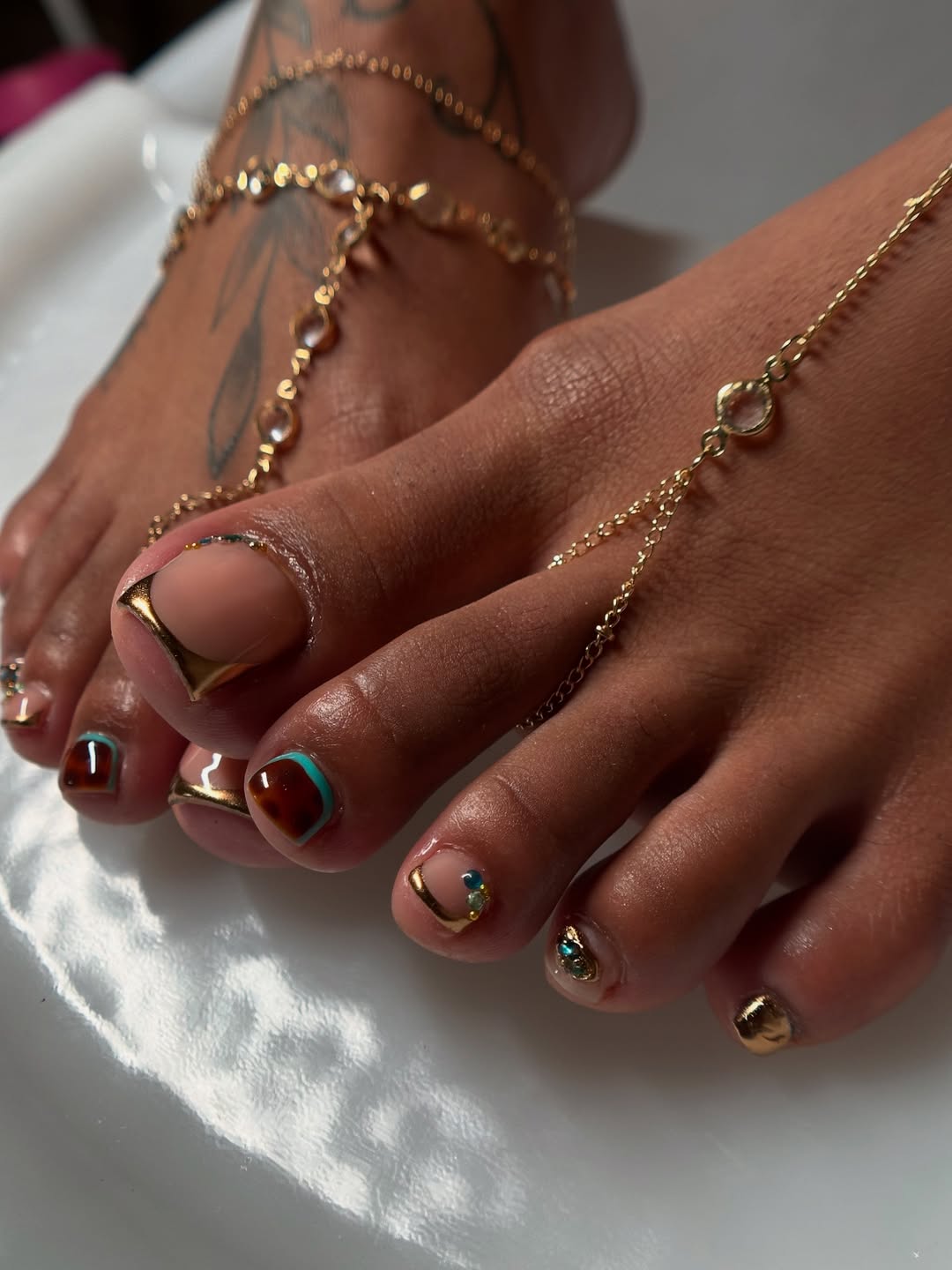 Gold Accented Tortoise Shell And Nude Pedicure