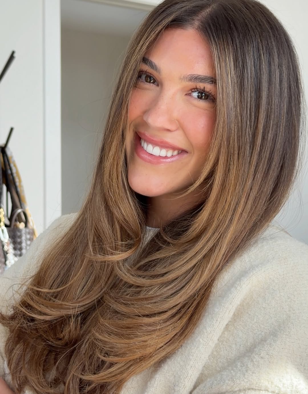 Chic Wavy Lob for Summer Medium Hair 2026 Woman with a chic, wavy lob styled with a deep side part, perfect for hairstyles summer medium hair. She wears a white eyelet top, offering a fresh, elegant summer look.