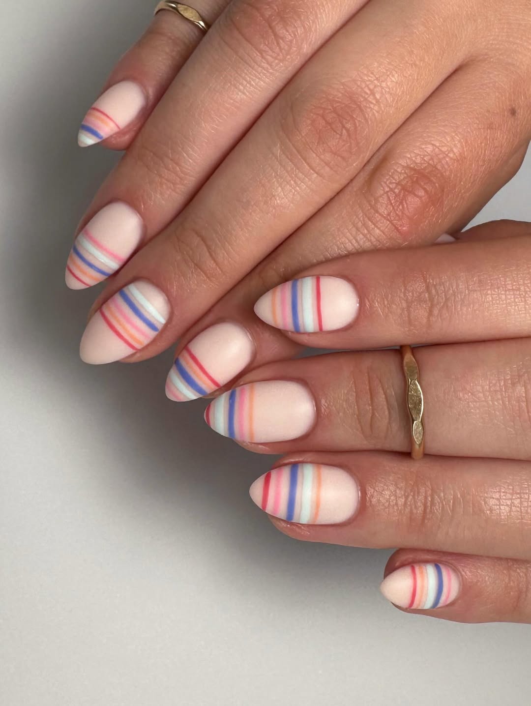 Matte Nude Almond Nails With Colorful Stripes