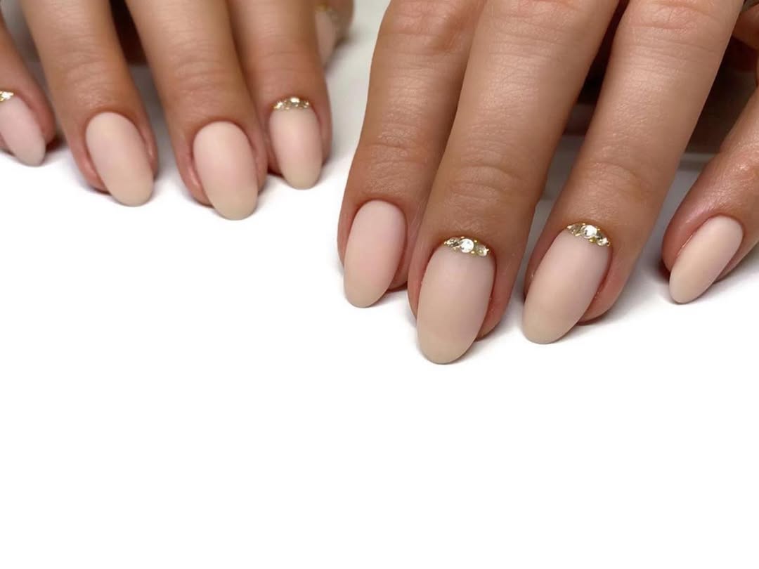 Matte Nude Almond Nails With Gold Rhinestone Cuticles