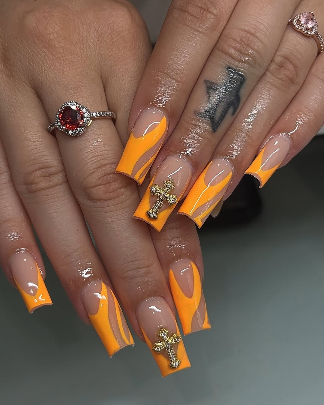 Neon Orange Swirl French Tips with Gold Cross Charms