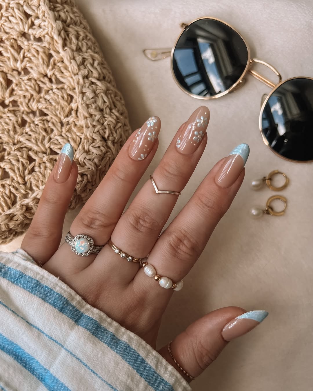 Nude Almond Nails with Blue French Tips and White Flowers