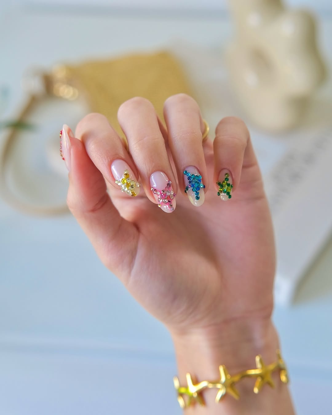 Nude Oval Nails with Rainbow Rhinestone Clusters
