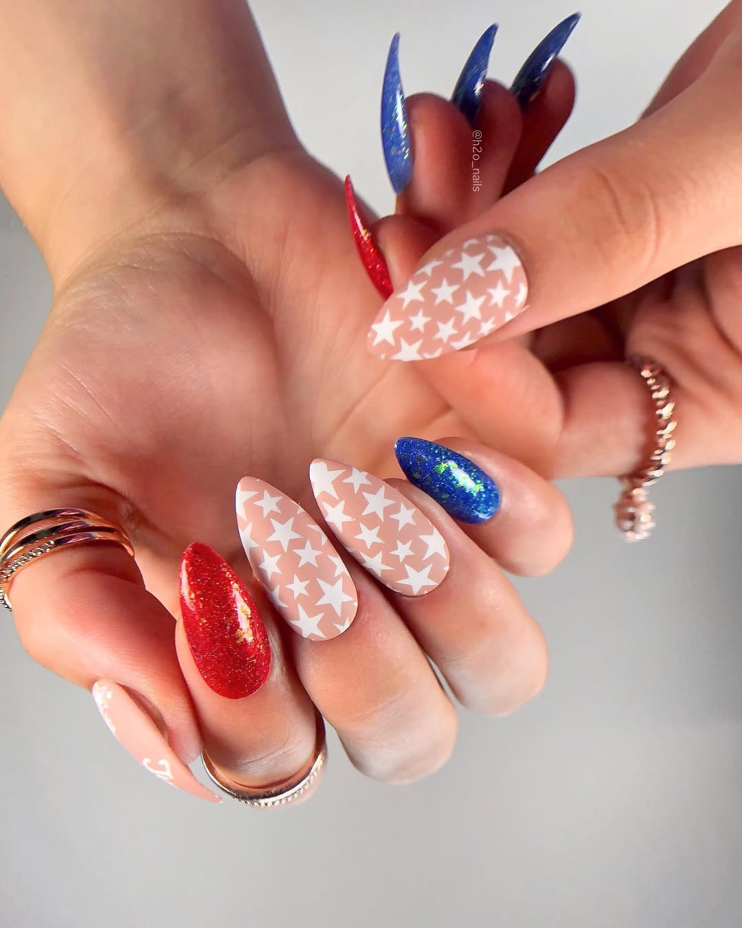 25 Patriotic Nail Ideas for 2026 You’ll Love 5 Patriotic Red White Blue Glitter Star Stiletto Nails