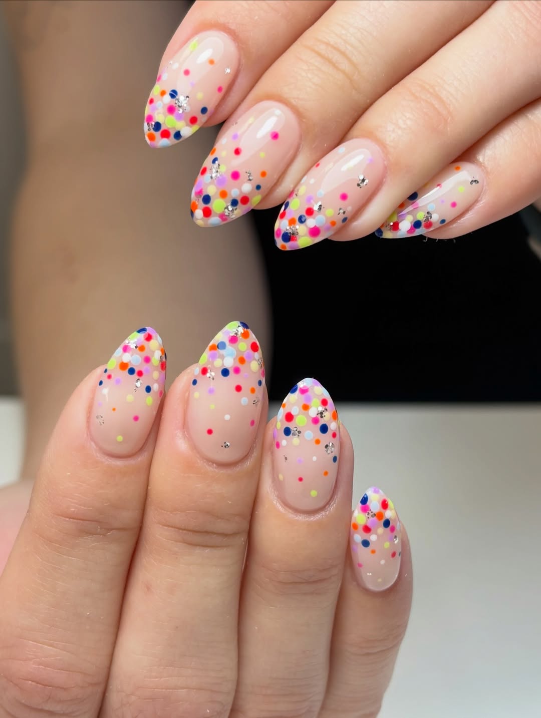 Playful Confetti Dot Almond Nails with Rhinestone Accents