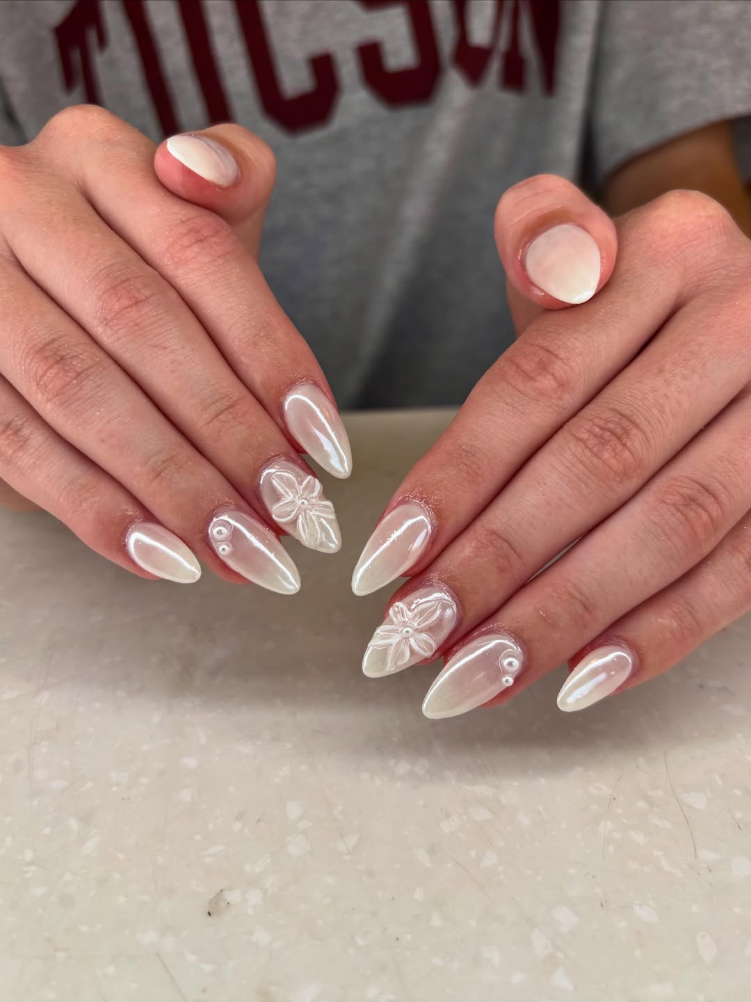 Shimmering White Almond Nails with 3D Floral Charms