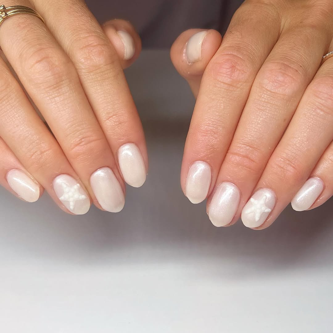 Shimmery Pearl White Nails With Subtle Starfish Detail