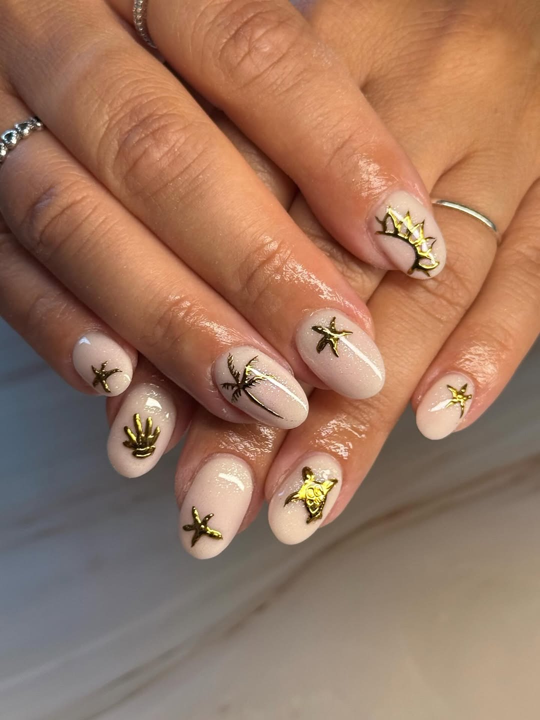 Sparkly Nude Oval Nails with Golden Beach Charms