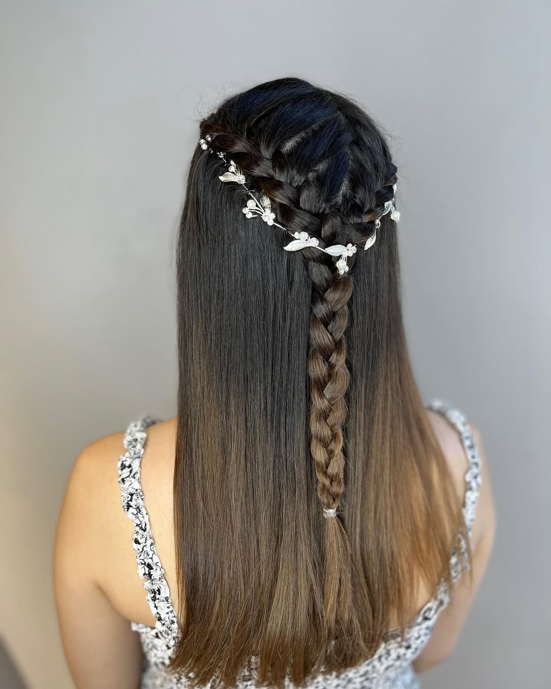 Close-up of a woman with a chic, messy fishtail summer braid hairstyle 2026, bohemian style for a relaxed day out.