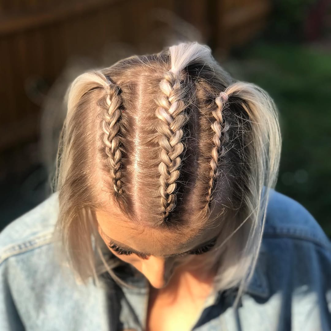 Close-up of a woman with long, sun-kissed hair styled in elegant summer braid hairstyles 2026, featuring a fishtail braid, perfect for a casual daytime look.
