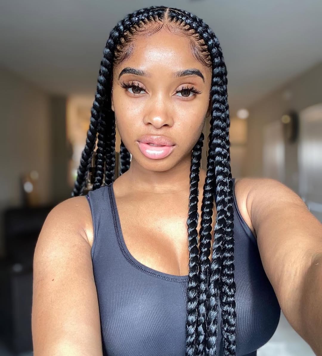 Woman wearing a loose fishtail summer braid hairstyle 2026 with an off-the-shoulder white top, perfect for a casual sunny day look.