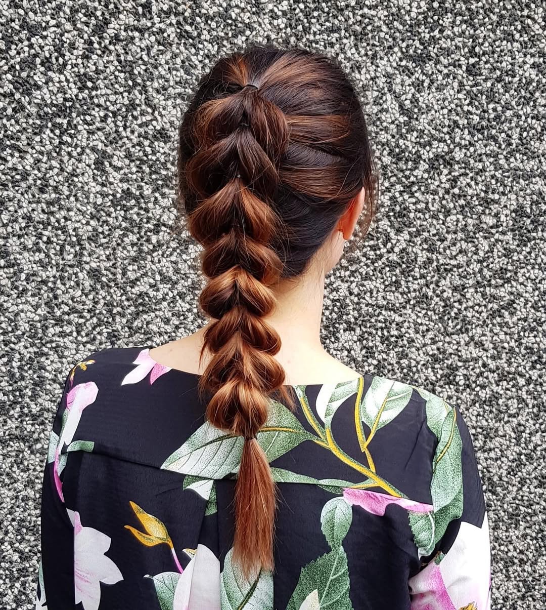 Close-up of a woman with long blonde hair styled in a chic, relaxed summer braid hairstyle 2026, perfect for a casual beach day or outdoor event.