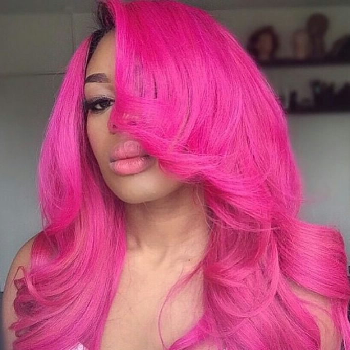 A woman wears her hair in a sleek, high ponytail with vibrant fuchsia streaks, showcasing cute summer hair colors 2026. Perfect for a chic daytime event.