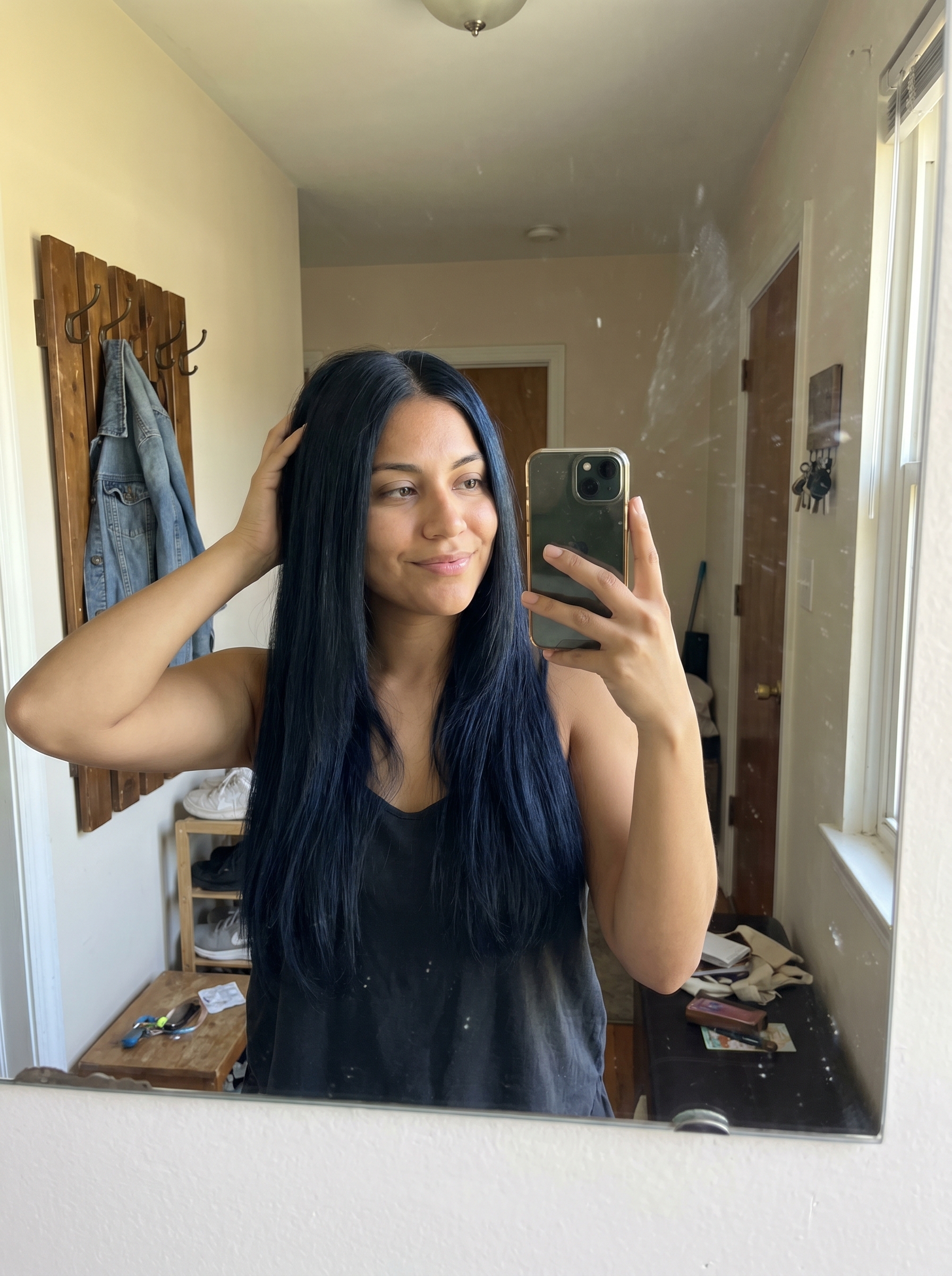 A sleek, edgy midnight blue-black hairstyle with a perfectly straight middle part, offering a mysterious and contemporary look for summer 2026. This cute hair color features deep blue undertones.