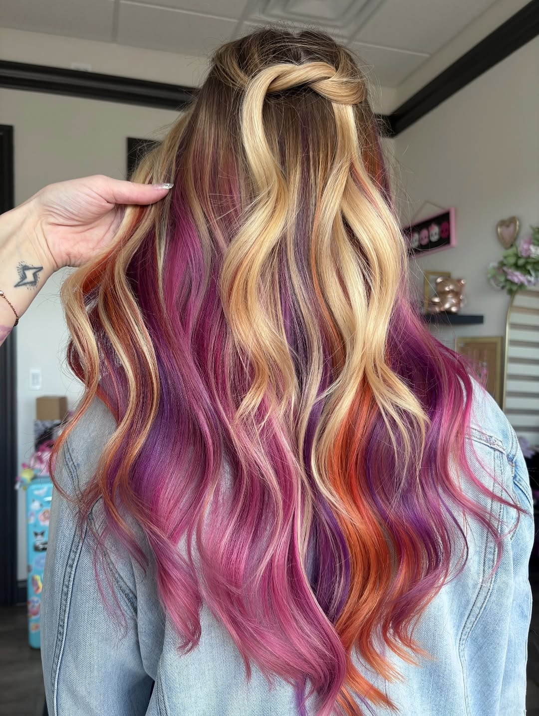 Blonde woman with long, shiny waves in a soft pastel pink dress, showcasing a beautiful summer hair trend 2026. Perfect for a garden party or casual elegant event.