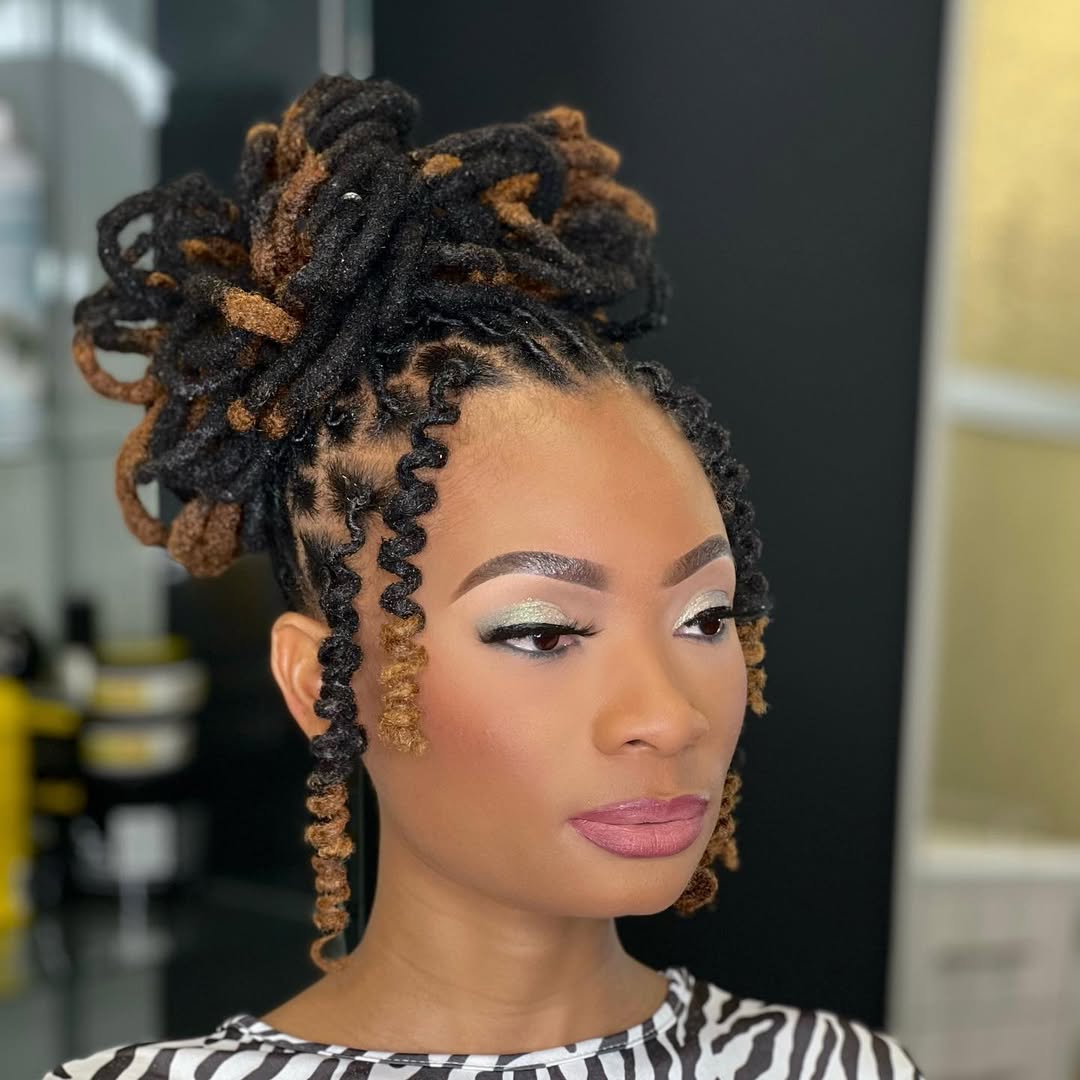 Beautiful black woman wearing a vibrant red off-shoulder top, showcasing stunning waist-length braided summer hairstyles black women 2026. Perfect for a casual day out.