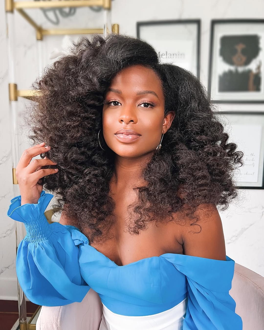 Beautiful black woman wearing a chic updo bun with braids, perfect for elegant summer hairstyles black women 2026. Her hair is intricately styled, showcasing a sophisticated and breezy look for warm weather event.