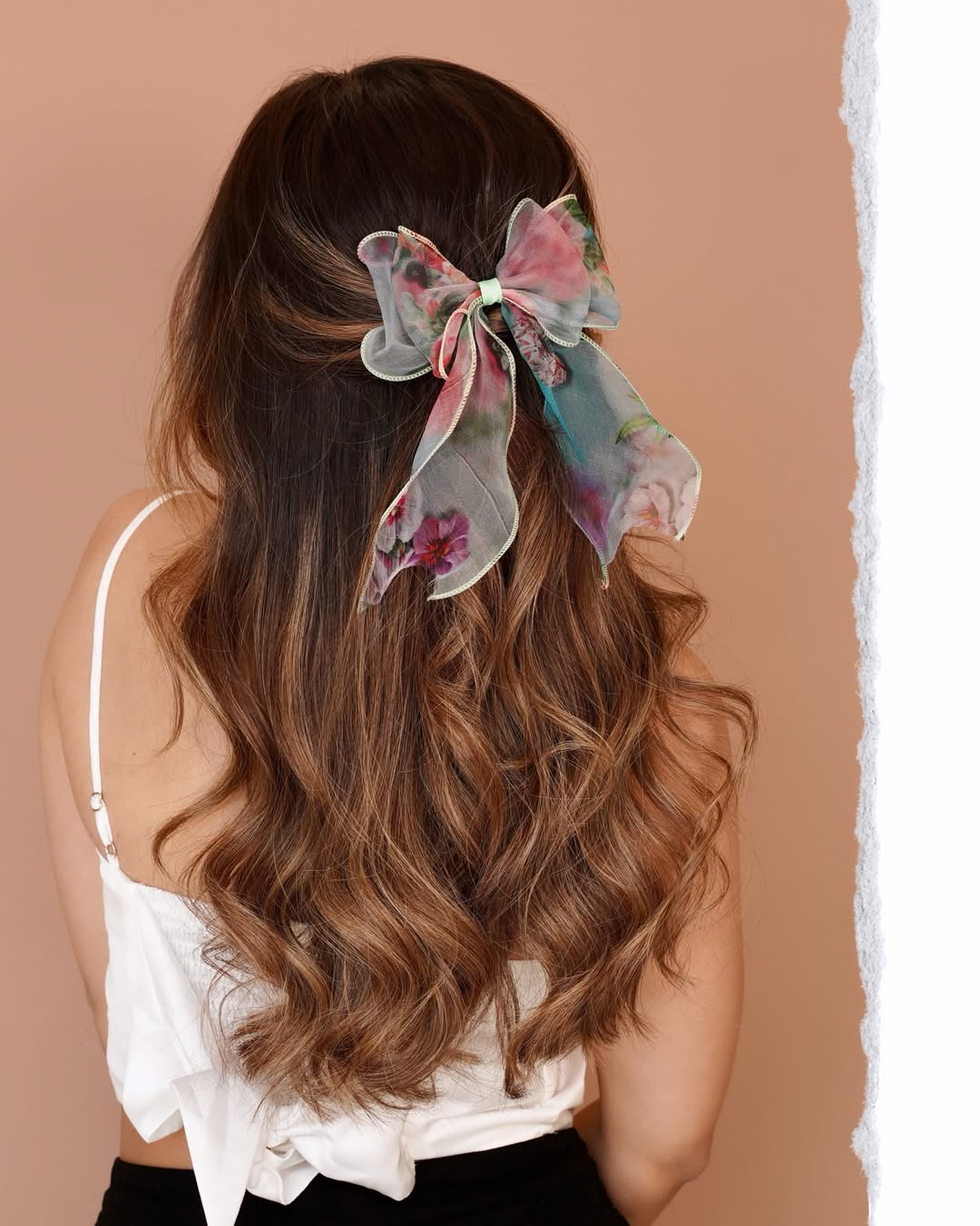 Woman with a chic, high braided bun for summer hairstyles hot weather, showcasing a sleeveless top and minimal jewelry, perfect for staying cool.