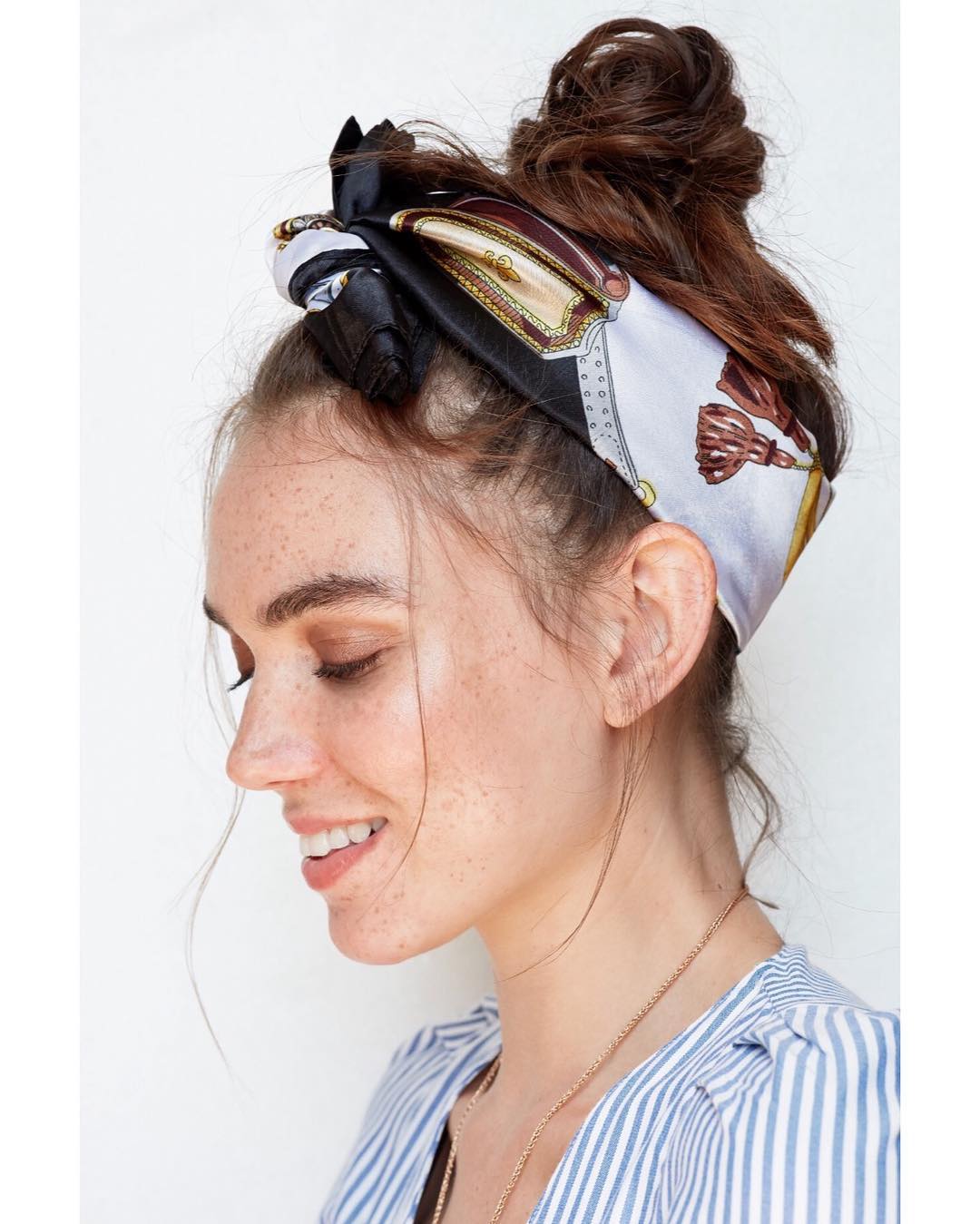 Blonde woman with a braided half-updo featuring delicate twists, perfect for summer hairstyles hot weather. Her hair is kept off her neck, showcasing its length.
