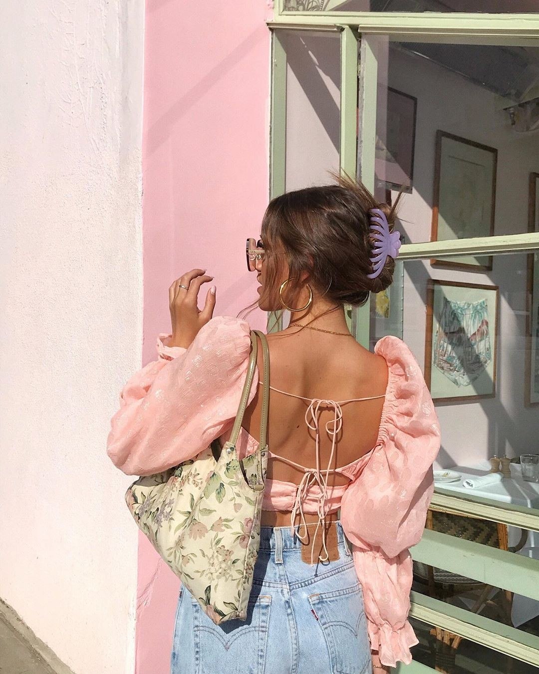 A woman wears a chic high ponytail, showcasing a flattering summer hairstyle perfect for hot weather, keeping hair off the neck.